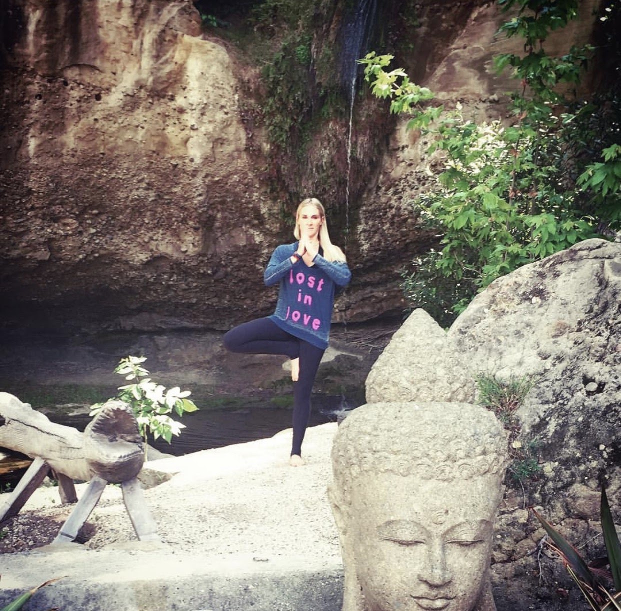 Torrie in a peaceful outdoor yoga setting